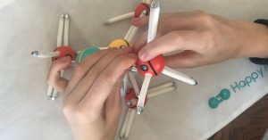 image of teen using "Happy Atoms" model building kit